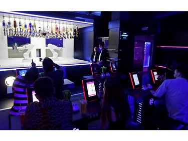 Customers order drinks from a robotic bartender in Karlovy Lazne Music Club in Prague, Czech Republic, July 18, 2019.