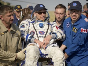 This handout photo released by NASA shows Expedition 59 Canadian Space Agency astronaut David Saint-Jacques being carried to a medical tent shortly after he, NASA astronaut Anne McClain, and Roscosmos cosmonaut Oleg Kononenko landed in their Soyuz MS-11 spacecraft near the town of Dzhezkazgan, Kazakhstan on June 25, 2019.