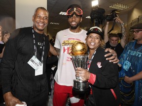 Former Raptors forward Kawhi Leonard poses with his uncle Dennis Robertson (left) as his mom holds his NBA MVP trophy after Toronto claimed the NBA title last month. (THE CANADIAN PRESS FILES)