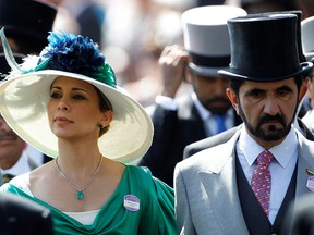 Jordanian Princess Haya bint Al-Hussein and her husband, Dubai ruler Sheikh Mohammed bin Rashid al-Maktoum (R), walk to the parade ring on Ladies Day, the third day of horse racing at Royal Ascot in southern England June 17, 2010.