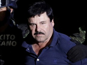 Recaptured drug lord Joaquin "El Chapo" Guzman is escorted by soldiers at the hangar belonging to the office of the Attorney General in Mexico City, Mexico January 8, 2016. (REUTERS/Henry Romero/File Photo)