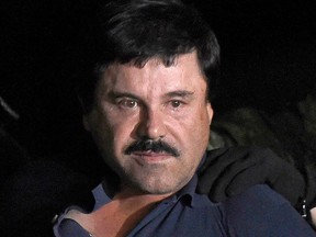 In this file photo taken on Jan. 8, 2016, drug kingpin Joaquin "El Chapo" Guzman is escorted into a helicopter at Mexico City's airport following his recapture during an intense military operation in Los Mochis, in Sinaloa State.