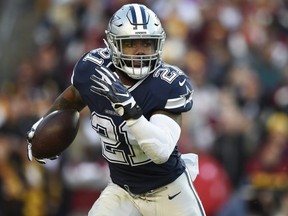Cowboys running back Ezekiel Elliott carries the ball against the Redskins at FedExField in Landover, Md., on Oct. 21, 2018.