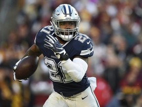 Cowboys running back Ezekiel Elliott carries the ball against the Redskins at FedExField in Landover, Maryland, on Oct. 21, 2018.
