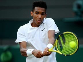 Felix Auger-Aliassime of Canada plays a backhand in his men's singles third round match against Ugo Humbert of France during Day 5 of Wimbledon at the All England Lawn Tennis and Croquet Club in London on July 5, 2019.