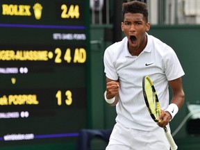 Felix Auger-Aliassime celebrates after winning a point against Vasek Pospisil during their men's singles first round match on the first day of the Wimbledon Championships at The All England Lawn Tennis Club in southwest London, on Monday, July 1, 2019.