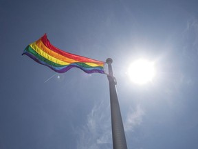 A rainbow flag flies at Toronto City Hall in Toronto on Tuesday, May 31, 2016. A lawyer says some victims of the federal government's gay purge were so devastated by the experience that even decades later they needed the help of a therapist to fill out forms to receive financial compensation.