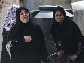 Relatives of 28-year-old Hamas fighter Mahmoud al-Adham mourn during his funeral in Jabaliya in the northern Gaza Strip on July 11, 2019. (MAHMUD HAMS/AFP/Getty Images)