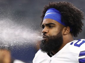 Dallas Cowboys' Ezekiel Elliott spits water before a game against the Detroit Lions at AT&T Stadium on Sept. 30, 2018 in Arlington, Texas.  (Ronald Martinez/Getty Images)