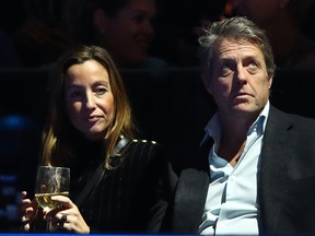 Hugh Grant and his wife Anna Eberstein watches the semi finals singles match between Roger Federer of Switzerland and Alexander Zverev of Germany during Day Seven of the Nitto ATP Finals at The O2 Arena on Nov. 17, 2018 in London.  (Clive Brunskill/Getty Images)