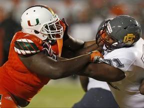 Kendrick Norton, left, of the Miami Hurricanes battles Phillip Norman of the Bethune-Cookman Wildcats during third quarter action on Sept. 5, 2015 at Sun Life Stadium in Miami Gardens, Fla.