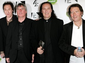 The Kinks band members, left to right, Ray Davies, Mick Avory, Dave Davies and Peter Quaife pose backstage with the award for their induction into the U.K. Music Hall Of Fame 2005 at Alexandra Palace on Nov. 16, 2005 in London. (MJ Kim/Getty Images)