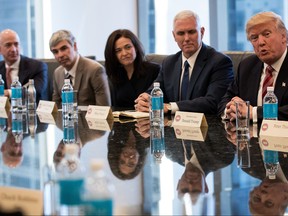 (L to R) Jeff Bezos, chief executive officer of Amazon, Larry Page, chief executive officer of Alphabet Inc. (parent company of Google), Sheryl Sandberg, chief operating officer of Facebook, Vice President-elect Mike Pence listen as President-elect Donald Trump speaks during a meeting of technology executives at Trump Tower, December 14, 2016 in New York City. This is the first major meeting between President-elect Trump and technology industry leaders.