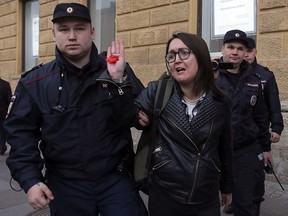 Police officers detain LGBT activist Yelena Grigoryeva during a rally against discrimination in Saint Petersburg April 17, 2019. (REUTERS/Anton Vaganov/File Photo)
