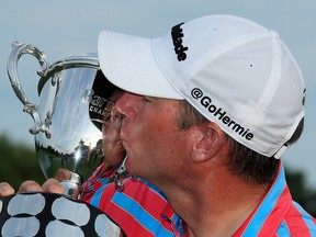 Jim Herman of the United States poses for a photo with the trophy after winning the Barbasol Championship at Keene Trace Golf Club on July 21, 2019 in Nicholasville, Ky.