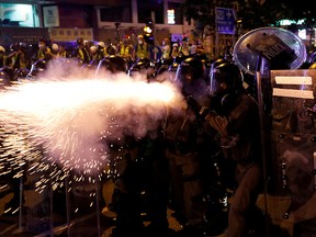 Riot police fire tear gas at anti-extradition demonstrators after a march to call for democratic reforms, in Hong Kong, China July 21, 2019.