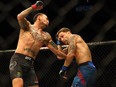 Max Holloway (L) fights Frankie Edgar during UFC 240 at Rogers Place, Edmonton, Saturday, July 27, 2019.