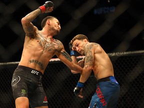 Max Holloway (L) fights Frankie Edgar during UFC 240 at Rogers Place, Edmonton, Saturday, July 27, 2019.
