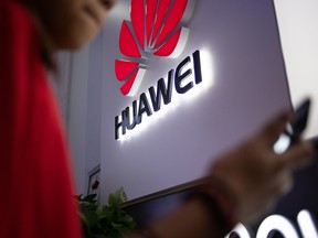 In this file photo taken on May 27, 2019, a Huawei logo is displayed at a retail store in Beijing.
