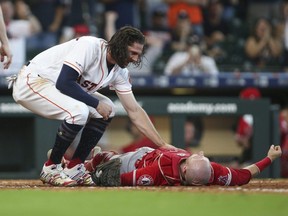 Astros centre fielder Jake Marisnick (left) reacts after a collision at the plate with Angels catcher Jonathan Lucroy (right) during eighth inning MLB action at Minute Maid Park in Houston on July 7, 2019.