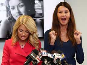 Attorney Lisa Bloom (left) and Janice Dickinson speak during a press conference to announce a settlement in their defamation lawsuit against Bill Cosby in Woodland Hills, Calif., on Thursday, July 25, 2019.