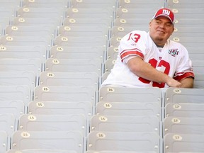 Quarterback Jared Lorenzen of the New York Giants sits in the stands during Giants media day for Super Bowl XLII at University of Phoenix Stadium in Glendale, Ariz., on Jan. 29, 2008.