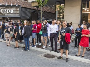 People gather across the street from Yorkville's Hazleton Hotel in the hopes that Kawhi Leonard may be inside, in Toronto on Wednesday July 3, 2019.