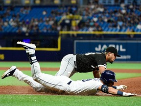 Jose Abreu of the Chicago White Sox gets beat to first base by Kevin Kiermaier of the Tampa Bay Rays during the eighth inning of a baseball game at Tropicana Field on July 20, 2019 in St. Petersburg, Fla. Kiermaier injured his left thumb on the slide in.