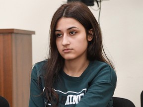 Krestina Khachaturyan, one of three teenage sisters accused of murdering their father, attends a hearing at a court in Moscow on June 26, 2019. (YURI KADOBNOV/AFP/Getty Images)