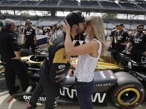 Canadian IndyCar driver James Hinchcliffe gets a kiss from Becky Dalton during the 2017 Indianapolis 500. They will get married in a few weeks.
