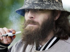 Eric Rook enjoys a strain of marijuana called NYC Diesel in Victoria Park in London.