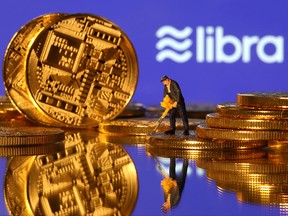 A small toy figure is seen on representations of virtual currency in front of the Libra logo in this illustration picture, June 21, 2019. (REUTERS/Dado Ruvic/Illustration/File Photo)