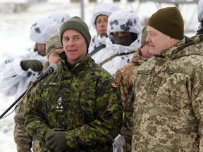 Canadian Army Lt.-Gen. Jean-Marc Lanthier, left, addresses Ukrainian soldiers as Ukrainian President Petro Poroshenko, right, stands by during military drills in base Honcharivske, Chernihiv region, Ukraine, Monday, Dec. 3, 2018. The military's top ranks are being shuffled again following the surprise resignation this week of the military's second-in-command. Defence officials say Lanthier is being tapped to be the new vice-chief of defence staff, the fifth officer to serve in that position since 2016.