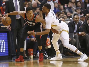 Portland Trail Blazers’ CJ McCollum is defended by Toronto Raptors Norman Powell in Toronto on Saturday March 2, 2019. (Jack Boland/Postmedia Network)