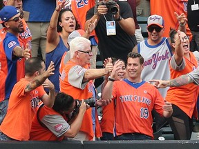 New York Mets general manager Brodie Van Wagenen (19) interacts with members of the Seven Line fan group during the first inning against the New York Yankees at Citi Field. (Brad Penner-USA TODAY Sports)