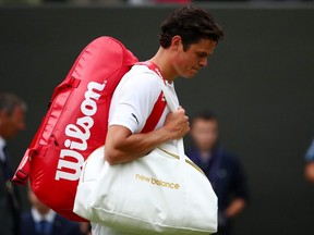 Milos Raonic leaves the court after his Wimbledon fourth round loss to Guido Pella of Argentina at the All England Lawn Tennis and Croquet Club, London, on Monday, July 8, 2019.