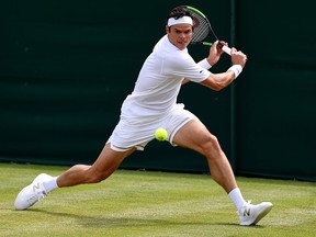 Milos Raonic of Canada plays a backhand in his Men's Singles third round match against Reilly Opelka of The United States during Day five of The Championships - Wimbledon 2019 at All England Lawn Tennis and Croquet Club on July 05, 2019 in London, England. (Mike Hewitt/Getty Images)