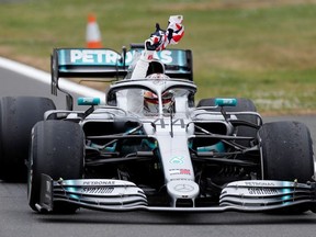 Mercedes' Lewis Hamilton waves a British flag as he celebrates after winning the race   REUTERS/Matthew Childs ORG XMIT: AI