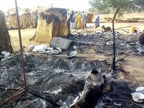 Smouldering ashes are seen on the ground in Budu near Maiduguri on July 28, 2019, after the latest attack this weekend by Boko Haram fighters on a funeral in northeast Nigeria.