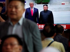 South Korean people watch a live TV broadcast on a meeting between North Korean leader Kim Jong Un and U.S. President Donald Trump at the truce village of Panmunjom inside the demilitarised zone separating the two Koreas, in Seoul, South Korea, June 30, 2019.