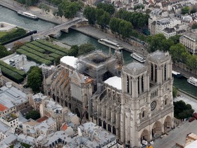 A view of the damaged roof of Notre-Dame during restoration work, three months after a fire that devastated the cathedral in Paris, July 14, 2019. (REUTERS/Philippe Wojazer/File Photo)