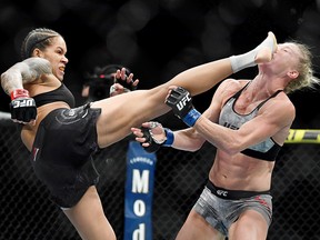 Amanda Nunes (left) lands a kick to the face of Holly Holm during UFC 239 at T-Mobile Arena in Las Vegas. (Stephen R. Sylvanie-USA TODAY Sports)