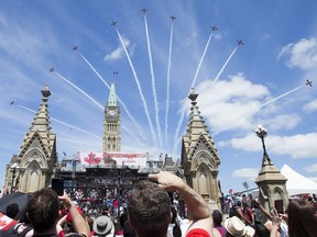 The Snowbirds fly over Parliament Hill as Canada Day activities are in full swing throughout Ottawa's downtown core on Monday, July 1, 2019.