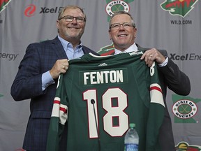 In this Tuesday, May 22, 2018 file photo Minnesota Wild owner Craig Leipold, left, poses with new general manager Paul Fenton during an introductory press conference in St. Paul, Minn. (Shari L. Gross/Star Tribune via AP, File)