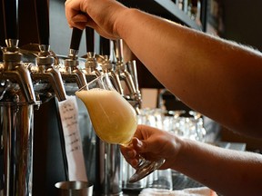 Cecilia Brawley pours a beer from a tap at the Dock Street Brewery in Philadelphia, Pa.