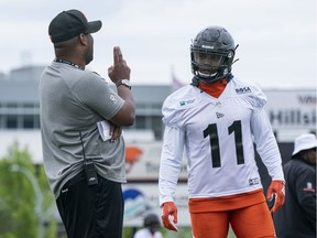 B.C. Lions head coach DeVone Claybrooks speaks with Odell Willis at practice during the Lions' 2019 Training Camp at Hillside Stadium in Kamloops.