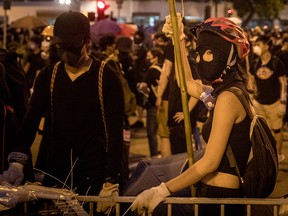 Protesters prepare equipment and barricades ahead of clashes with police after taking part in a pro-democracy march on July 14, 2019 in Hong Kong, China.