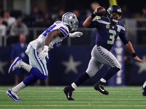 Russell Wilson of the Seattle Seahawks passes the ball under pressure from Randy Gregory of the Dallas Cowboys at AT&T Stadium on January 5, 2019 in Arlington. (Tom Pennington/Getty Images)