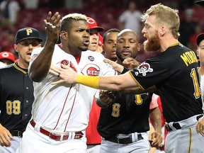 Yasiel Puig of the Cincinnati Reds is restrained during a bench clearing altercation against the Pittsburgh Pirates at Great American Ball Park on July 30, 2019 in Cincinnati. (Andy Lyons/Getty Images)