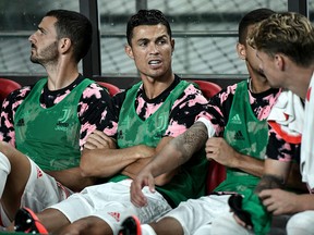 Juventus's Cristiano Ronaldo (middle) sits on the team bench prior to a friendly against the Team K League in Seoul on July 26, 2019. (Jung Yeon-je / AFP)